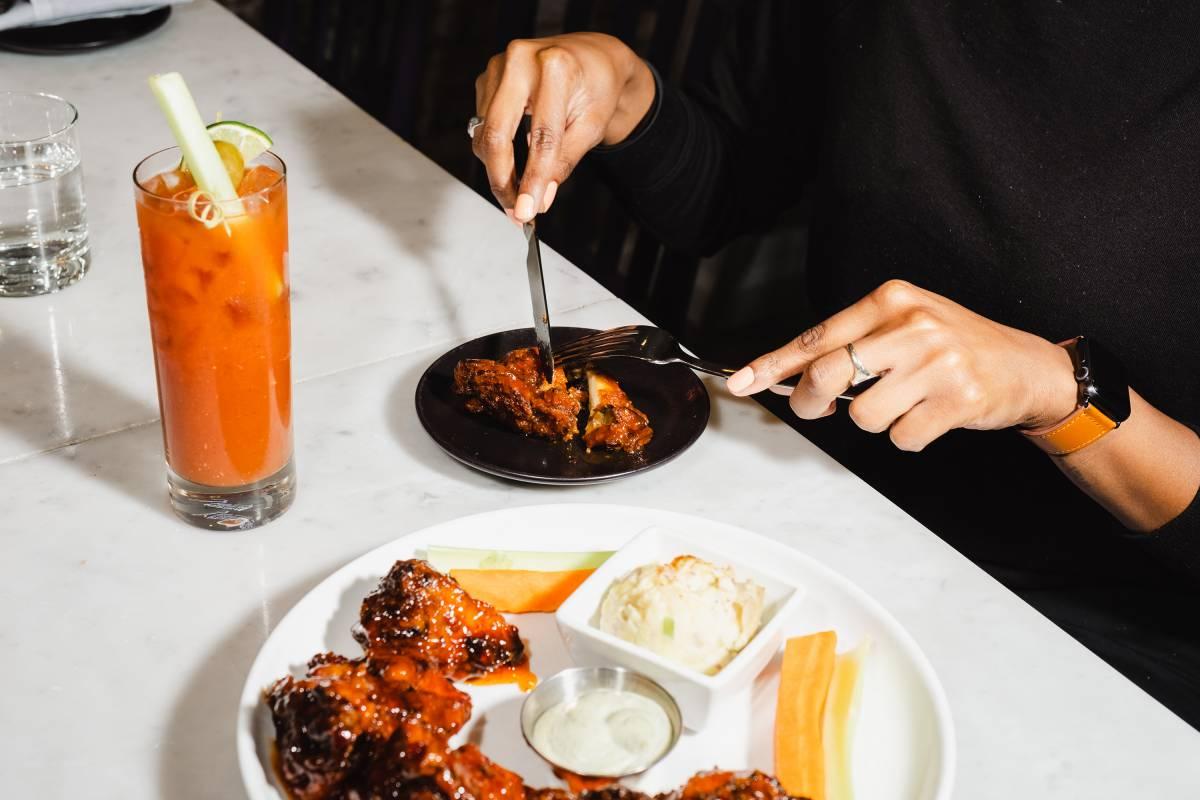image of a person using utensils to cut their meal